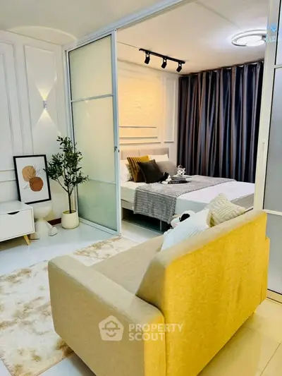 Stylish bedroom with cozy seating area and modern decor