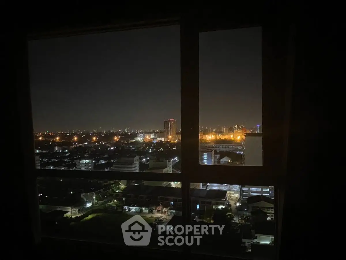 Stunning cityscape night view from high-rise apartment window.