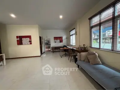 Spacious living room with modern decor and large windows for natural light.