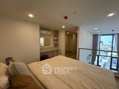 Modern bedroom with city view, featuring cozy bed and stylish decor in high-rise apartment.