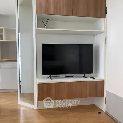 Modern living room with sleek TV unit and wooden flooring