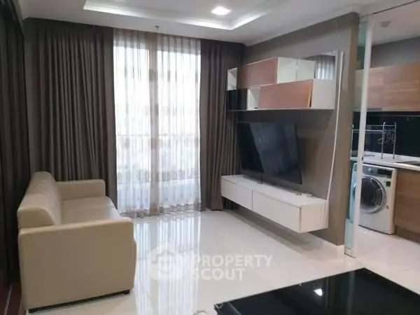 Modern living room with sleek furniture and integrated kitchen appliances