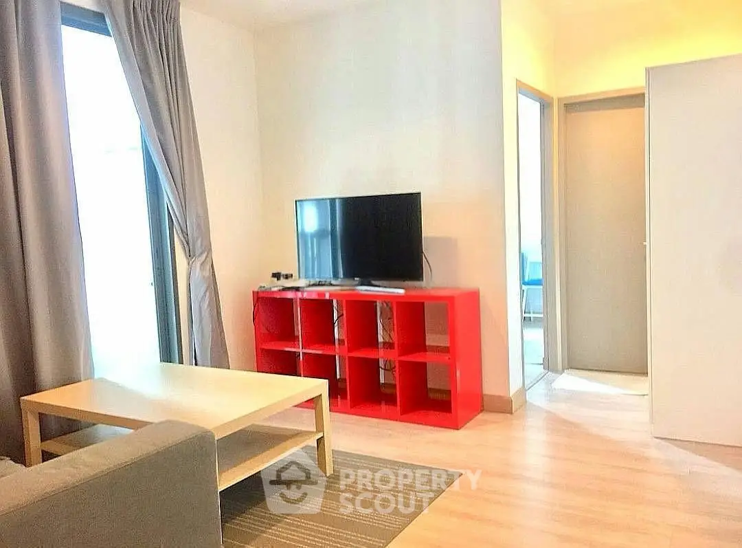 Modern living room with red TV stand and cozy seating area