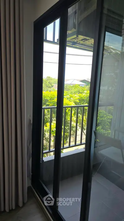 Charming balcony view with lush greenery from a cozy apartment