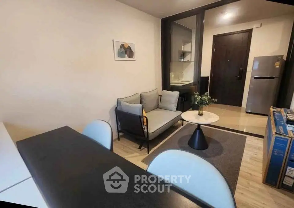 Modern living room with cozy seating and stylish decor in a contemporary apartment.