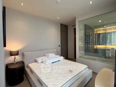 Modern bedroom with glass wall bathroom and cozy lighting
