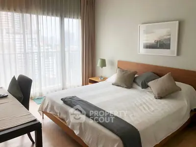 Modern bedroom with large window and stylish decor in urban apartment