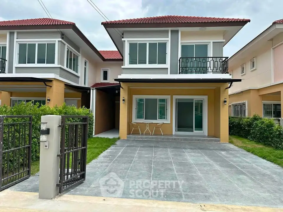 Modern two-story house with red roof, spacious driveway, and small balcony in a suburban neighborhood.