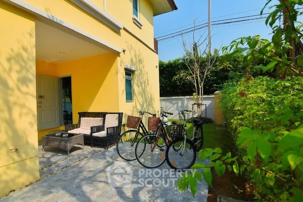 Charming garden patio with bicycles and cozy seating area in sunny backyard