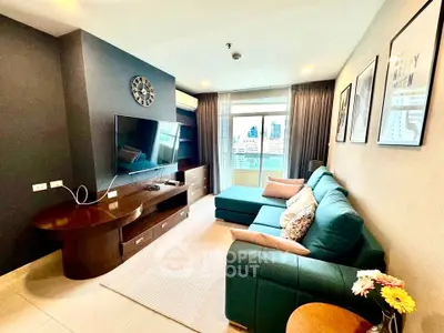 Modern living room with city view, stylish decor, and comfortable seating in a high-rise apartment.