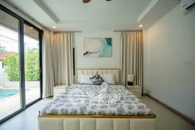 Luxurious bedroom with pool view and elegant decor