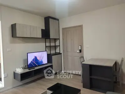 Modern living room with sleek furniture and wall-mounted TV, perfect for cozy relaxation.
