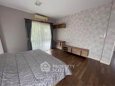 Spacious bedroom with elegant decor and natural light