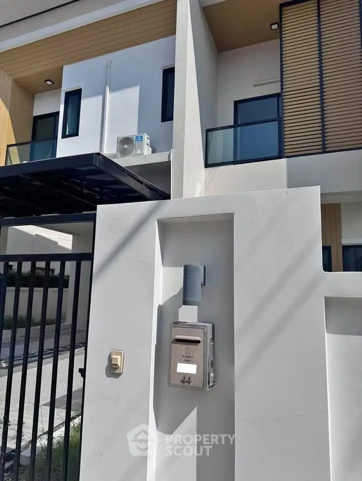 Modern townhouse exterior with sleek design and air conditioning unit