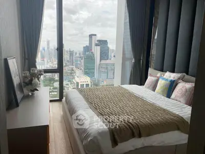 Luxurious bedroom with stunning city view from floor-to-ceiling windows in high-rise apartment.