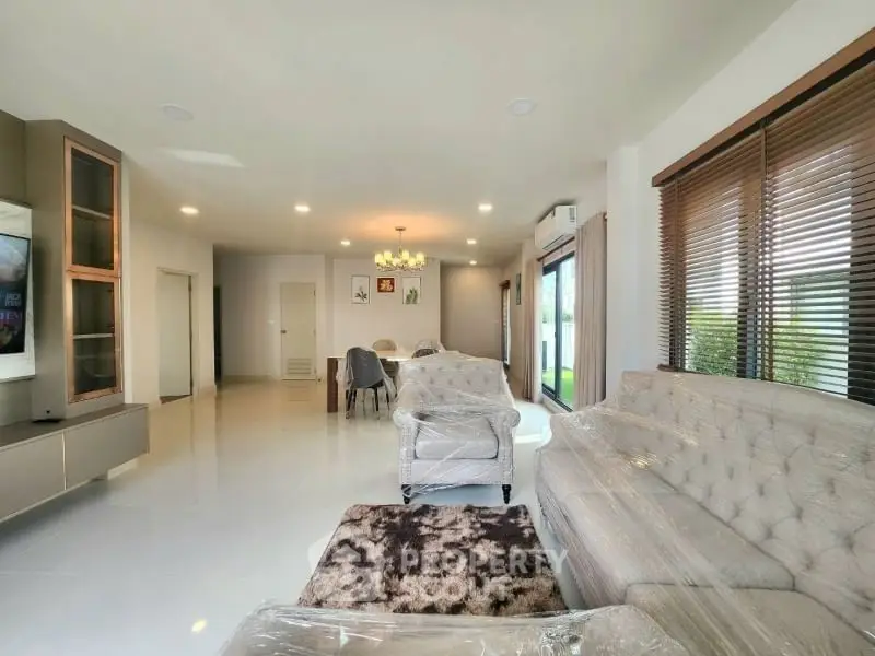 Spacious modern living room with elegant furniture and large windows for natural light.