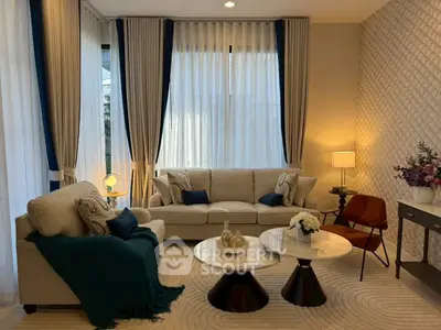 Elegant living room with modern decor, plush seating, and ambient lighting.