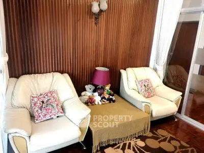 Cozy living room with plush seating and elegant wooden paneling