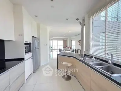 Spacious modern kitchen with sleek design and ample natural light