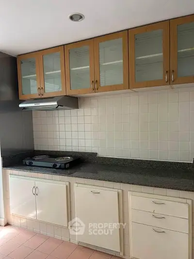Modern kitchen with sleek cabinets and gas stove, perfect for culinary enthusiasts.