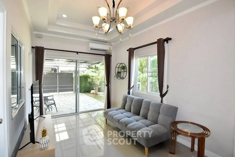 Spacious living room with modern decor and garden view