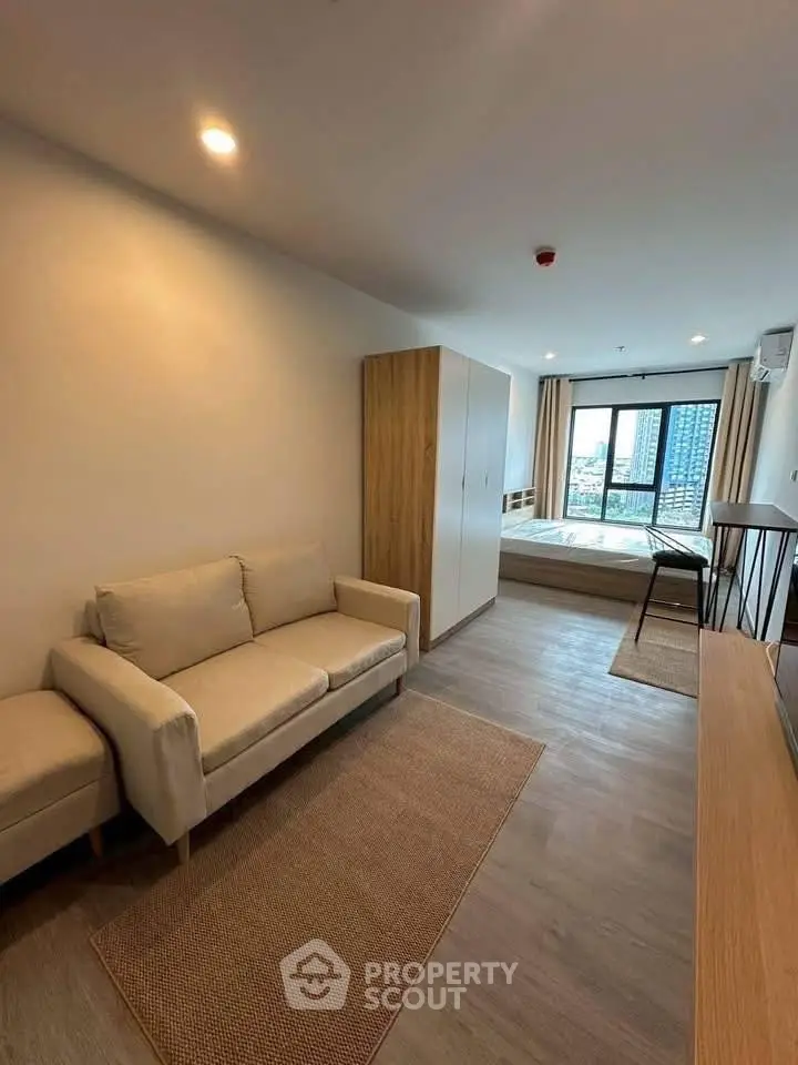 Modern studio apartment with cozy living area and city view