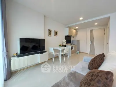 Modern living room with sleek furniture and open kitchen layout in stylish apartment