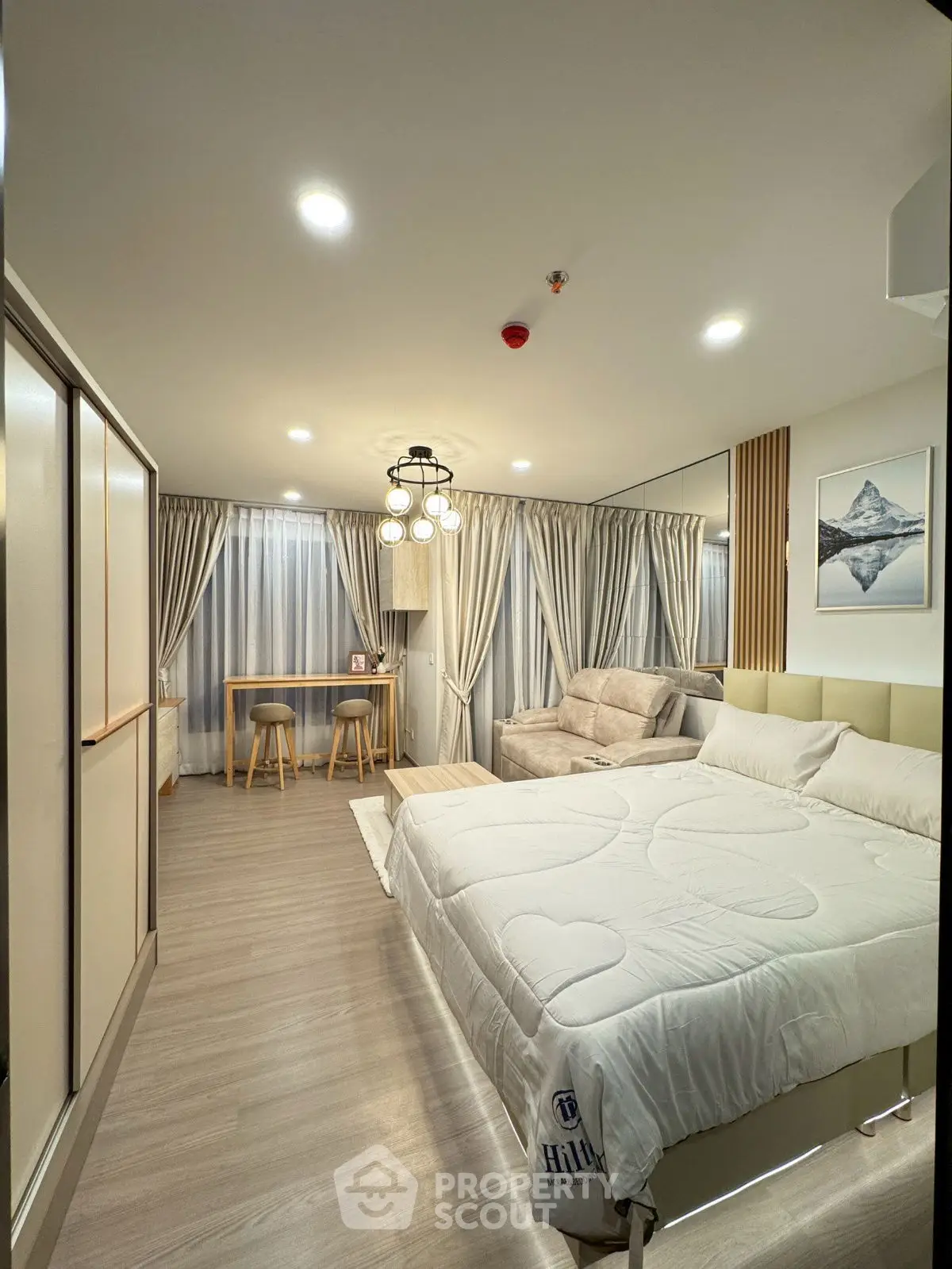 Modern bedroom with elegant decor and cozy seating area