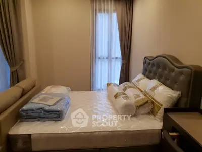Cozy bedroom with elegant bed and soft lighting, perfect for relaxation.