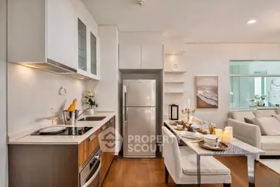 Modern kitchen with sleek design and dining area, featuring wooden flooring and contemporary decor.
