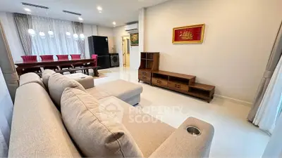 Spacious living room with modern furniture and dining area, perfect for family gatherings.