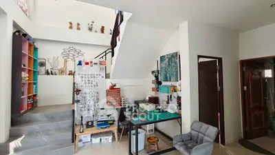 Spacious modern living area with unique decor and open staircase