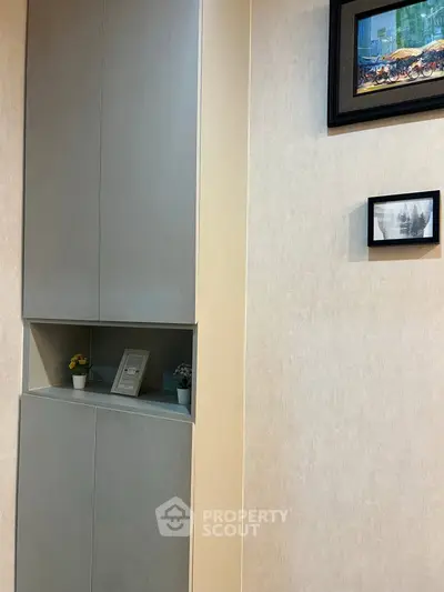 Modern interior with sleek storage and decorative wall art in a stylish living space.