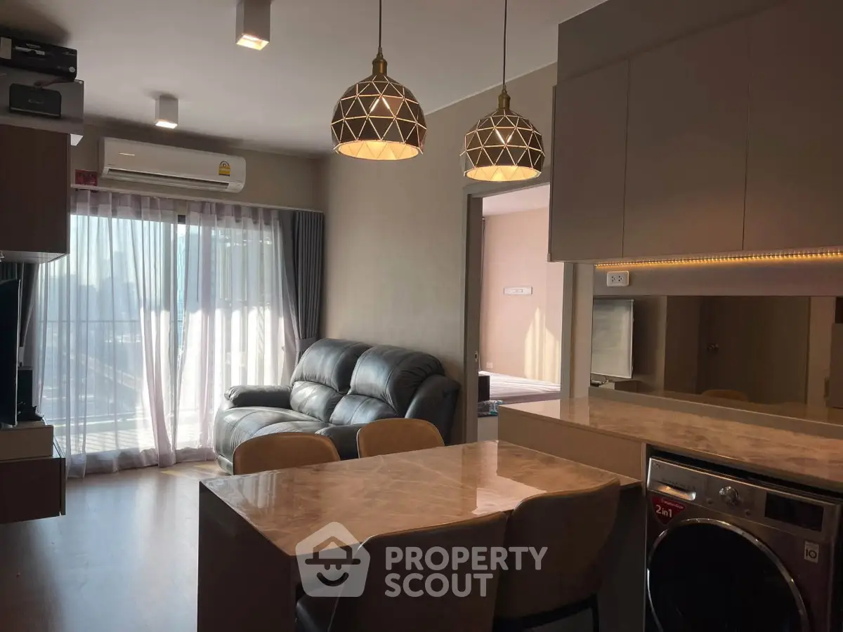 Modern living room with stylish lighting and open kitchen layout