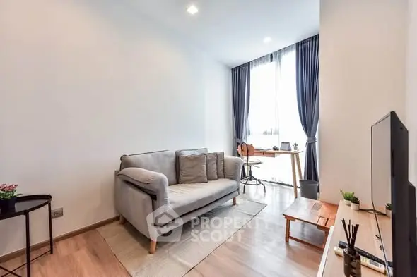 Modern living room with cozy sofa and natural light, perfect for relaxation and entertainment.