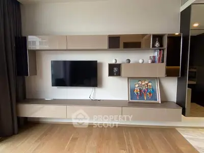 Modern living room with sleek wall-mounted TV and stylish storage units.