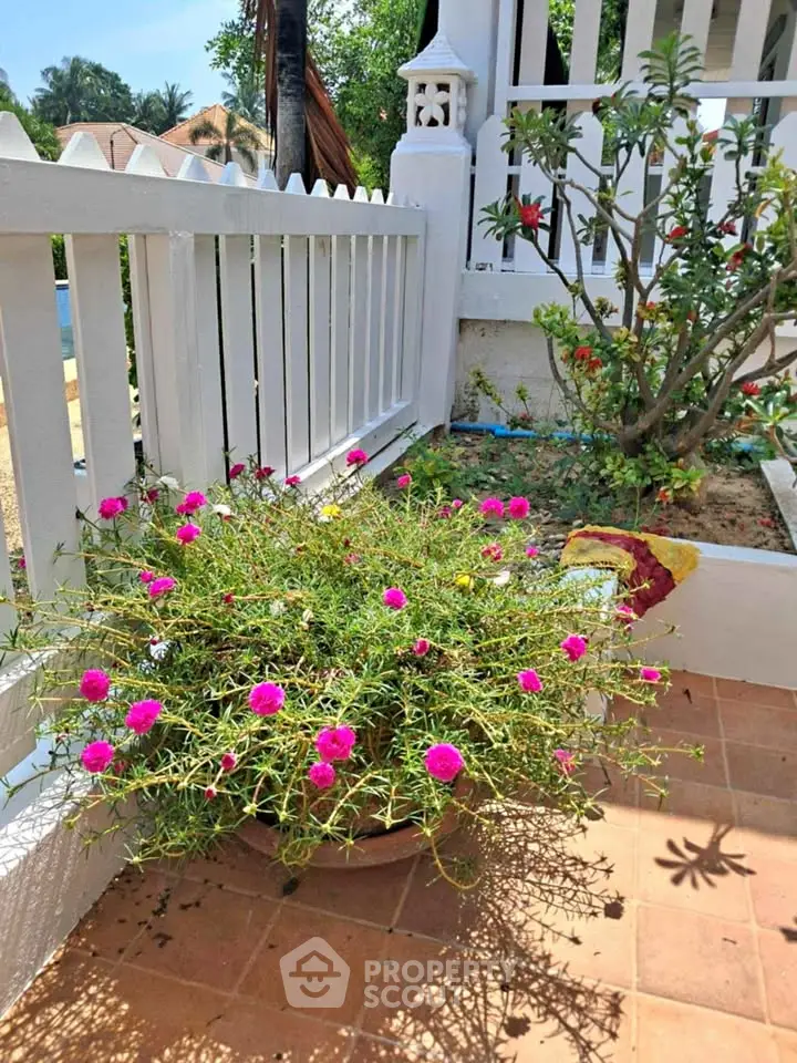 Charming garden corner with vibrant flowers and white picket fence