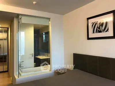 Modern bedroom with glass-enclosed bathroom and stylish decor