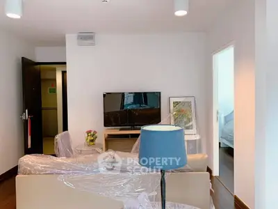 Modern living room with TV, sofa, and stylish decor in a cozy apartment.