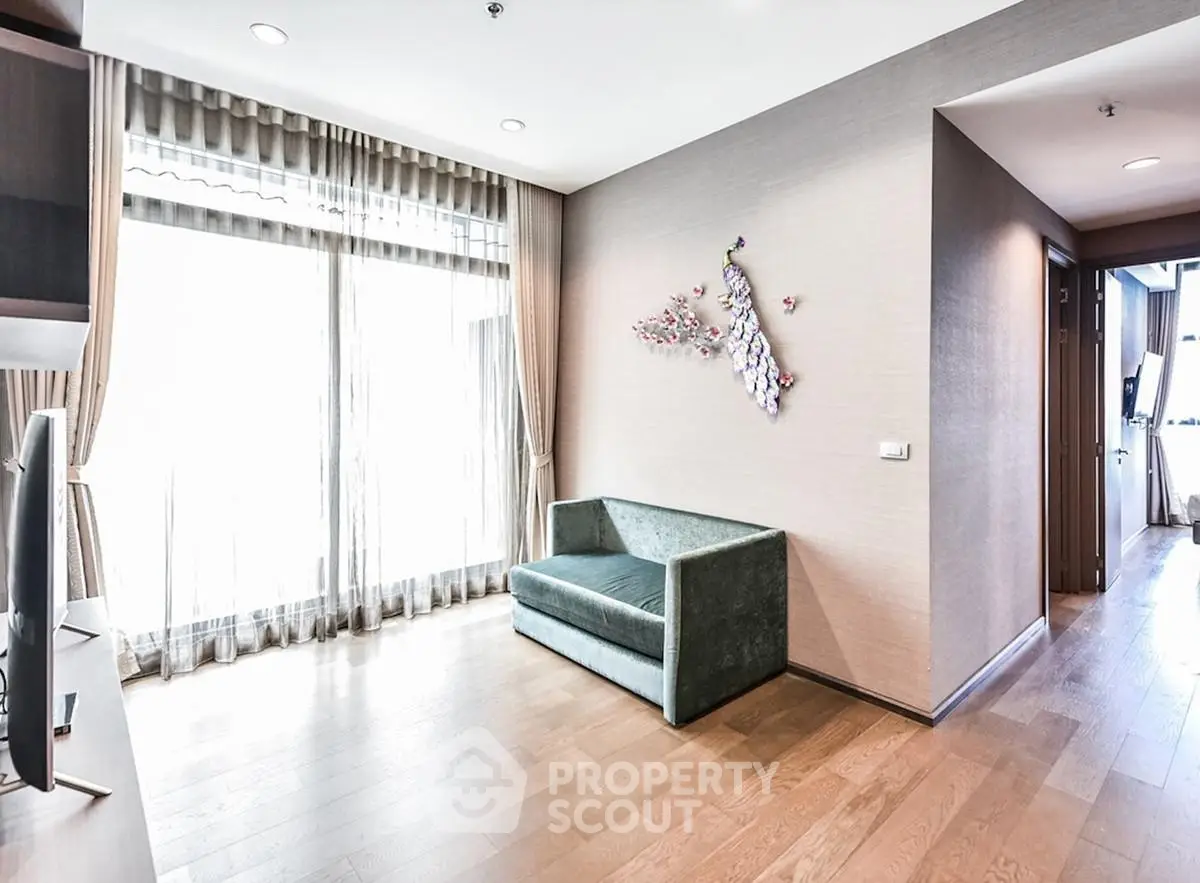 Spacious living room with elegant decor and large windows offering natural light.