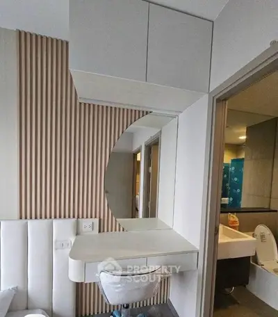 Modern bedroom with stylish vanity and bathroom view