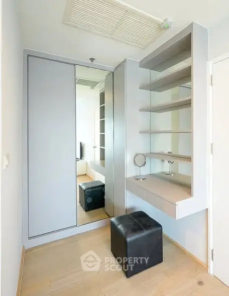 Modern minimalist dressing area with mirror and shelves in a bright room