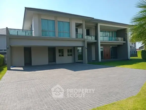 Luxurious modern two-story house with spacious driveway and lush green lawn