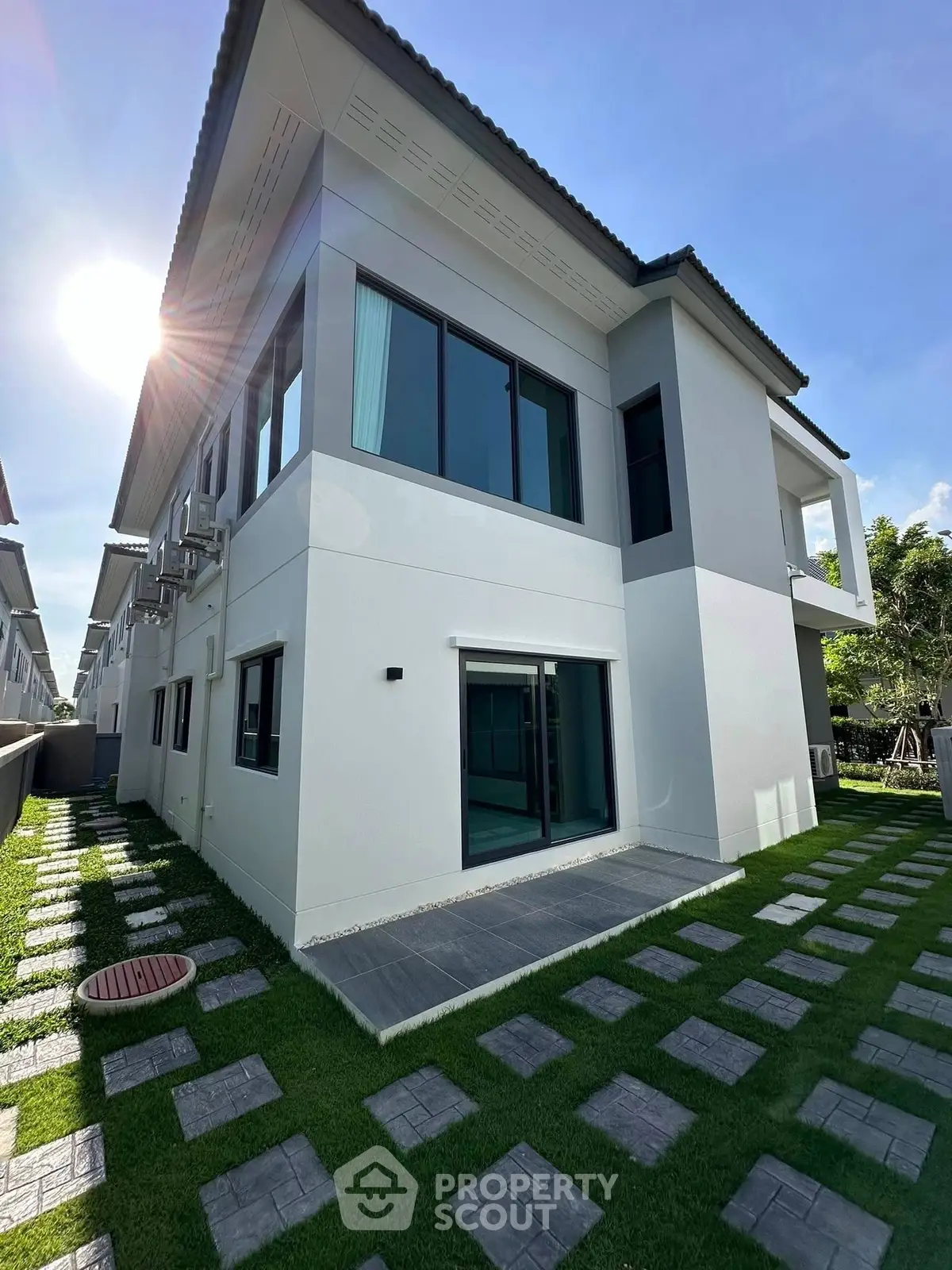 Modern two-story house with sleek design and lush green lawn