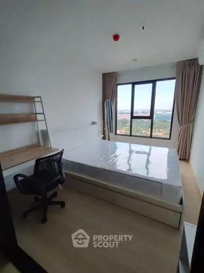 Modern bedroom with large window offering stunning city view, featuring a sleek bed and ergonomic chair.