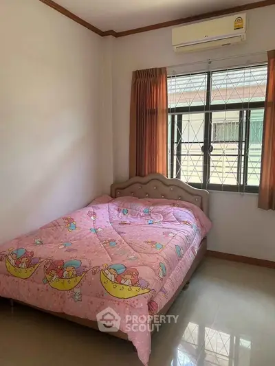 Cozy bedroom with colorful bedding and natural light from window