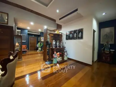 Elegant living room with wooden flooring and decorative statues