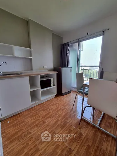 Modern kitchen with open layout and balcony view in a cozy apartment