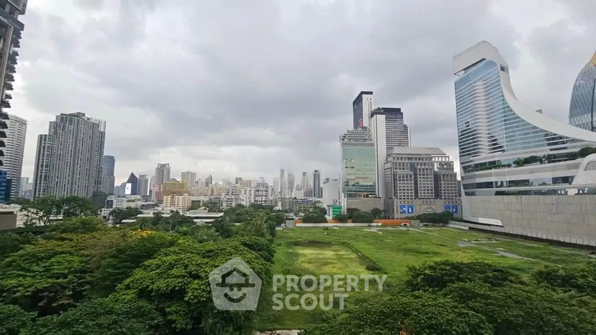 Stunning cityscape view with lush greenery and modern skyscrapers, perfect for urban living enthusiasts.