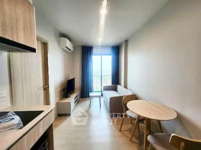 Modern living room with natural light, cozy seating, and stylish dining area in a compact apartment.